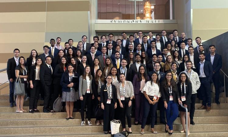 A large group of students posing on stairs