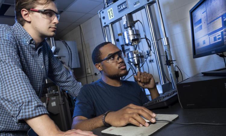   Grad student Alexander Caputo (left) and SURE student Benjamin Pollard work in Richard Neu’s lab.