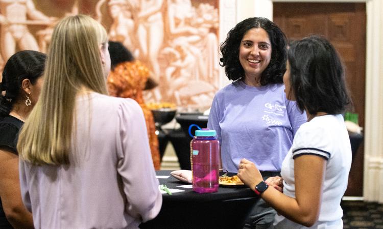 Students talk with a member of the Society of Women Engineers at the group's annual Tea with the Dean welcome event.