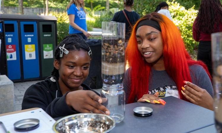 woman watching student with water filtration system