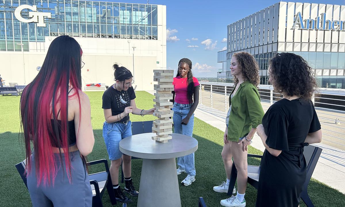 Students play jumbo Jenga on the Coda rooftop